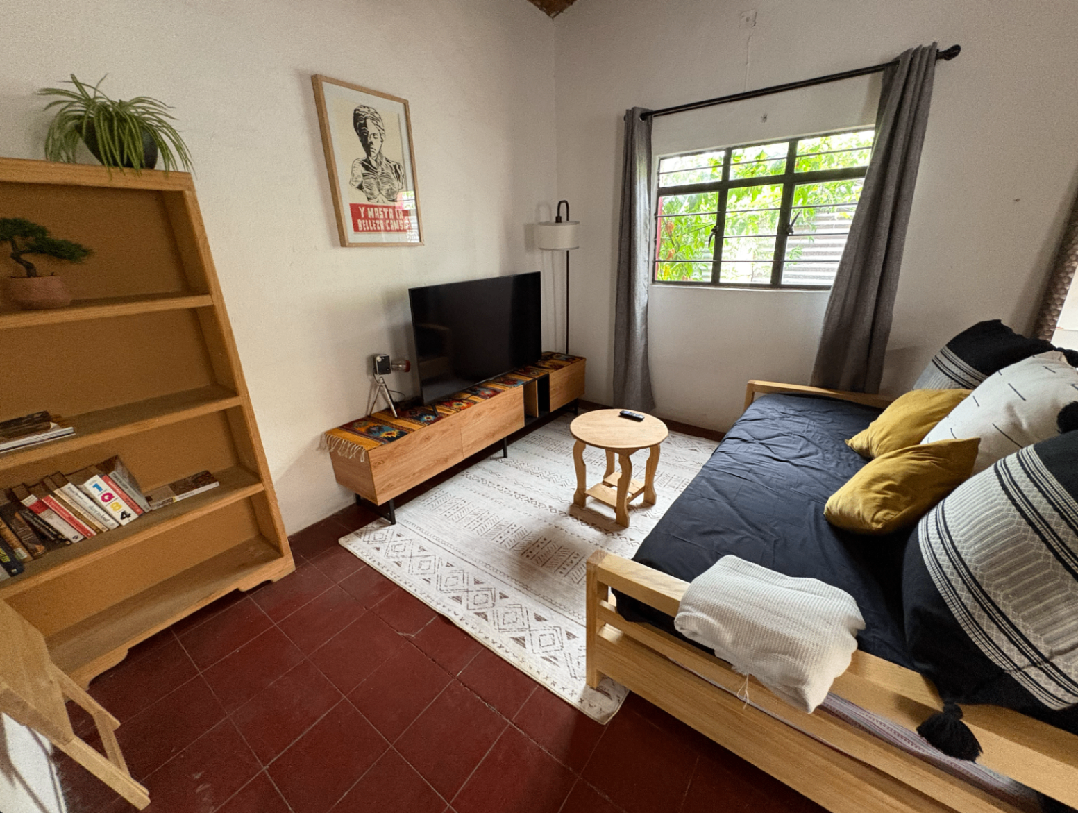 Casa del Colibrí living room with wood furniture, soft textiles, and bright natural light.