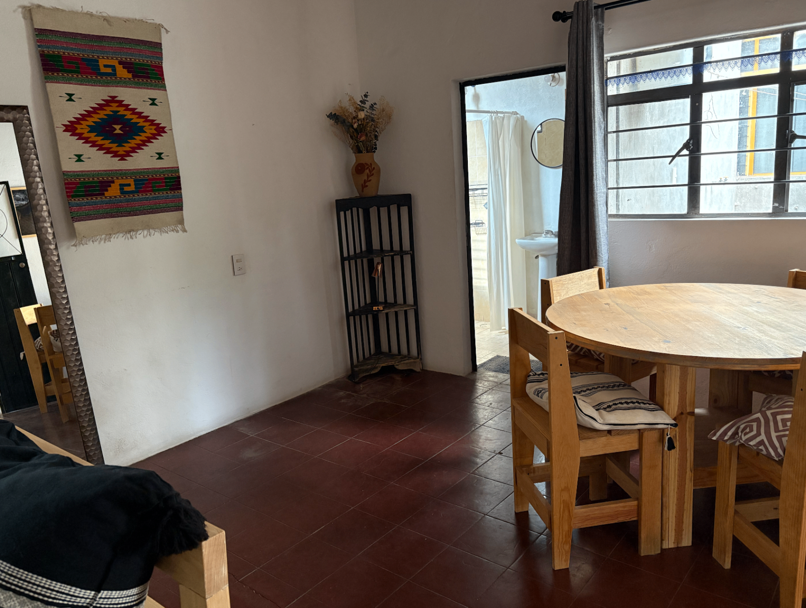 Dining area with round wooden table.